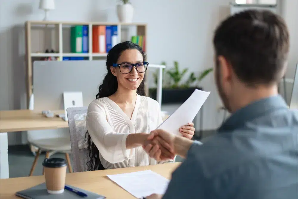 smiling female personnel manager job applicant shaking hands after successful employment with employee benefits employee benefits