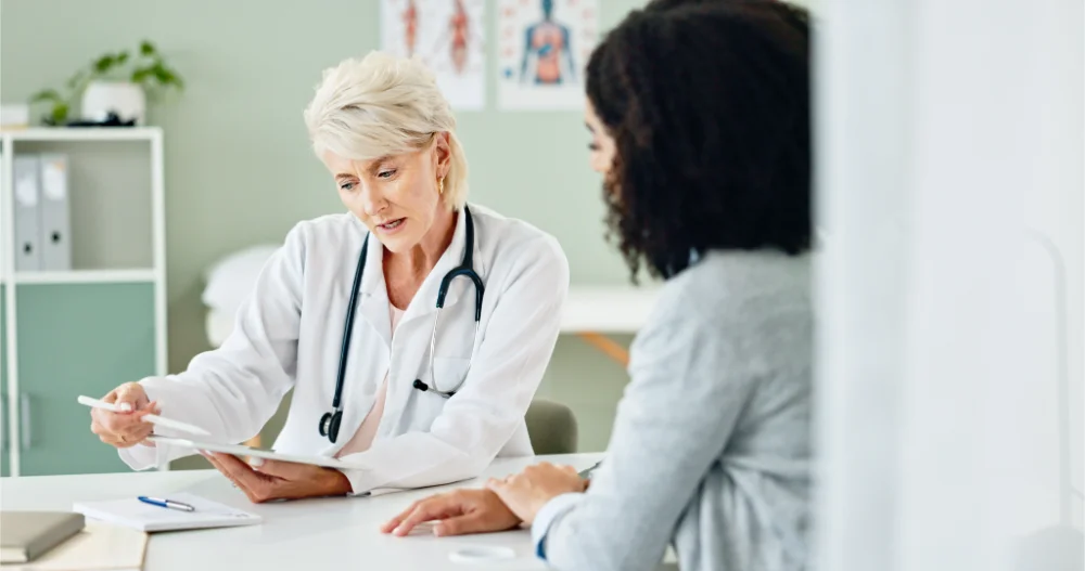women consulting with doctor about fertility issues paid with fertility spending account fertility spending account