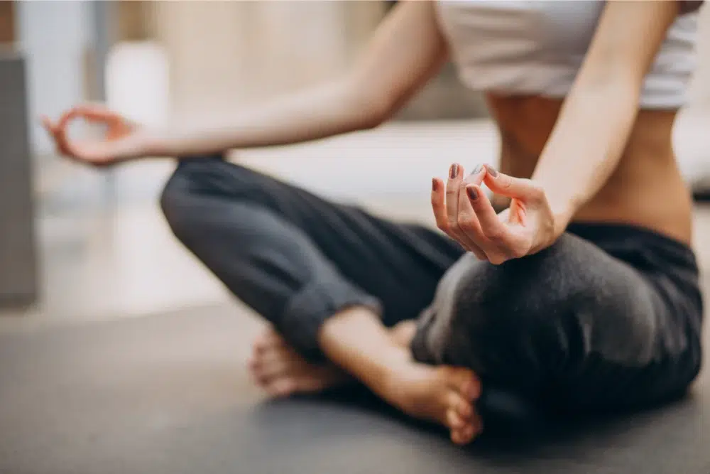 young woman practicing yoga home lifestyle spending accounts