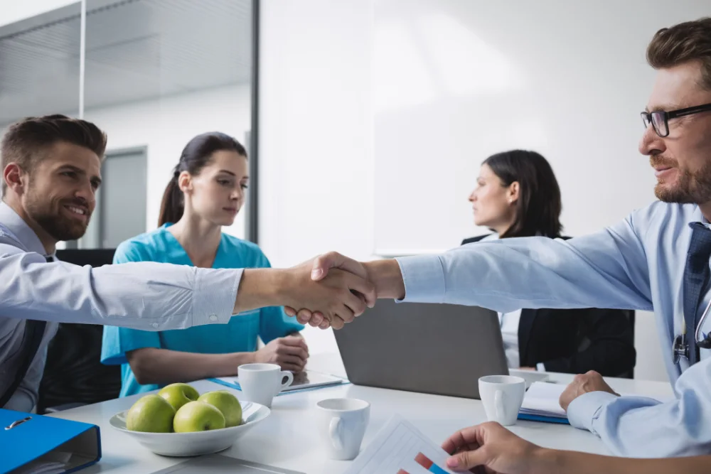 doctors shaking hands with each other deferred profit sharing plan