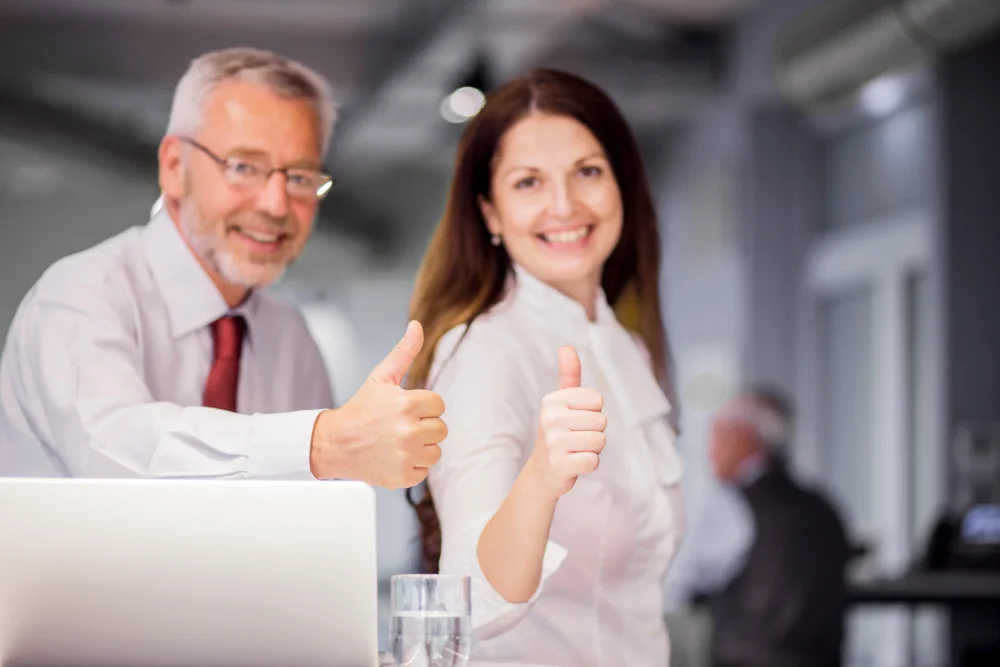 smiling successful businesspeople showing thumb up sign office deferred profit sharing plan