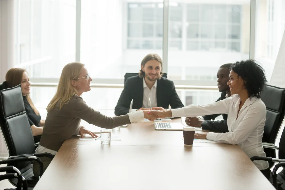 diverse smiling businesswomen shaking hands greeting multiracial group meeting group registered retirement savings plan